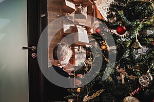 Child near advent calendar with small gifts