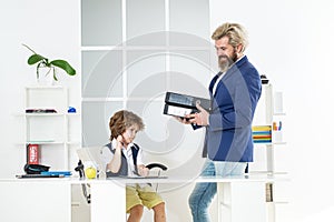 Child in office. Business man talking with young worker in office. Business people at office and consulting. Managing