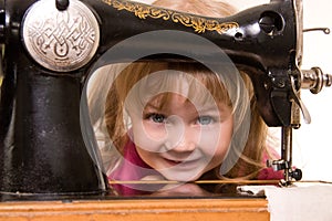 Child at old sewing-machine