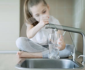 Child open tap. Kitchen faucet. Filtration system, water purification at home. Hydration. Healthy lifestyle. Water quality check