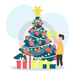 The child opening Christmas gifts for winter holidays. Christmas tree