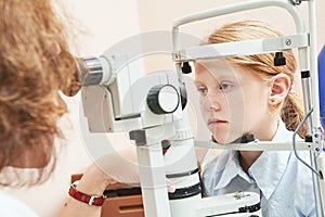 Child ophthalmology. female doctor checks eyesight at girl