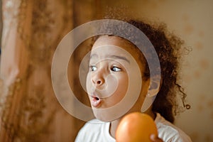 Child with oranges. Happy little girl with fruit.