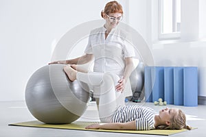 Child orthopedist using gym ball