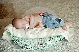 Child with pacifier asleep in crib