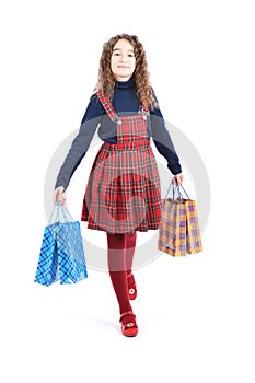 Child with a packaging checkered texture isolated on white background. Girl likes shopping on sale season. Holiday present,