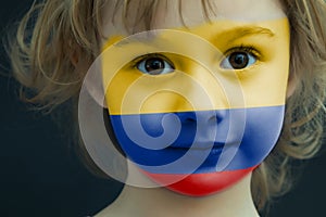 Child with a painted flag of Columbia