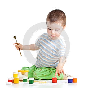 Child painting with brush