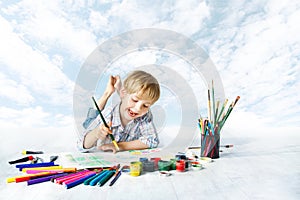 Child painting with color brush, drawing tools, creative kid