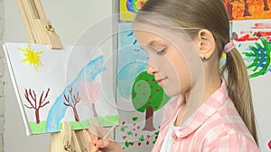 Child painting on easel, school kid in workshop class, girl working art craft
