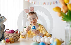 child painting eggs