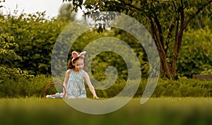 child with painting eggs outdoors