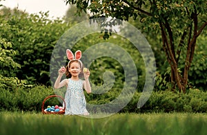 child with painting eggs outdoors