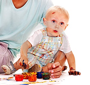 Child painting by finger paint.