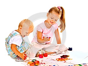 Child painting by finger paint.