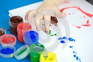 Child painting with fingers