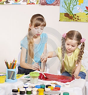 Child painting in preschool.