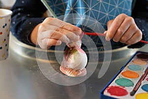 Child painting stone easter bunny