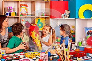 Child painting on table. Girl make candy cone schultuete.