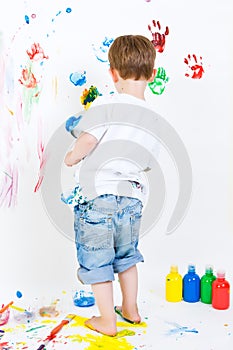 Child painting on the wall