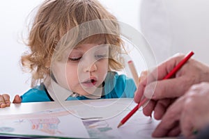 Child and parent drawing together