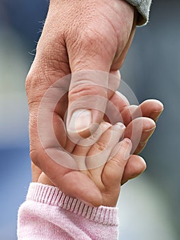 Child and parent holding hands