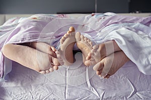 Child with parents sleeping together on the bed