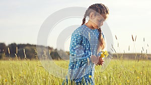 child in the park. little girl picking flowers in a field in the park. lifestyle happy family kid dream concept. allergy