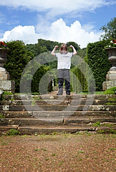 Child park steps arms raised