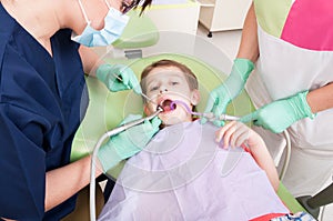 Child patient drilling procedure in dental office