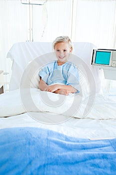 Child patient sitting on a hospital bed