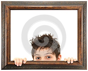 Child Peeking Out of Ornate Wooden Frame