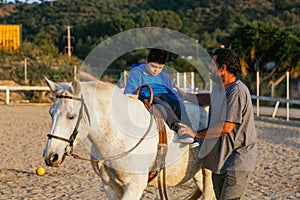 Child performing rehabilitation exercises during equine therapy