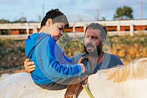 Child performing upper trunk exercises during equine therapy