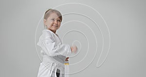 The child performs a special exercise for karate. A diligent athlete performs various exercises.