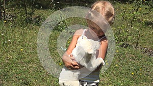 Child Petting her Dog, Kid Kissing a Puppy, Little Girl Playing on Meadow, Children Love Pets, Animals