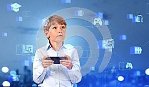 Child with phone in hands, IOT with digital icons and future technology