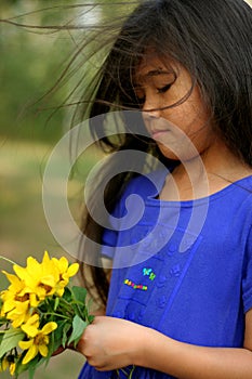 Child picking sunflowers