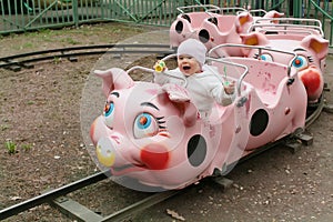 Child on piggy train in entertainment park