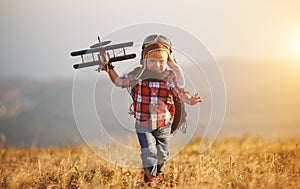 Child pilot aviator with airplane dreams of traveling in summer