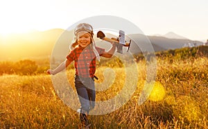 Child pilot aviator with airplane dreams of traveling in summer