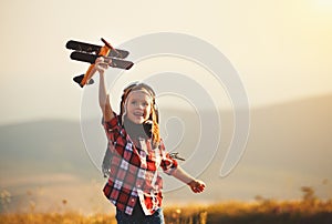 Child pilot aviator with airplane dreams of traveling in summer