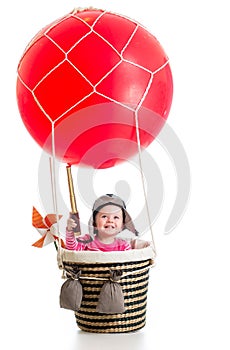 Child with pilot hat and teleskop on hot air balloon