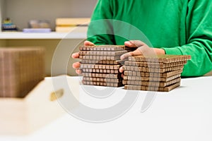 Child placing some blocks to count numbers is his house, concept of homeschooling