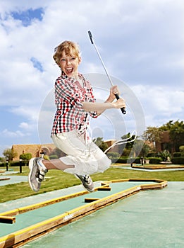 Child plaing golf. Child golfer.