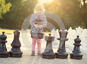 Child play chess figures outdoor