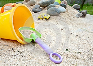 Child play game with bucket and sand