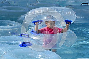 Child play with Inflatable clear inner tubes