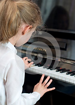 Child play the piano.