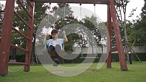 Child play on swing in playground happy